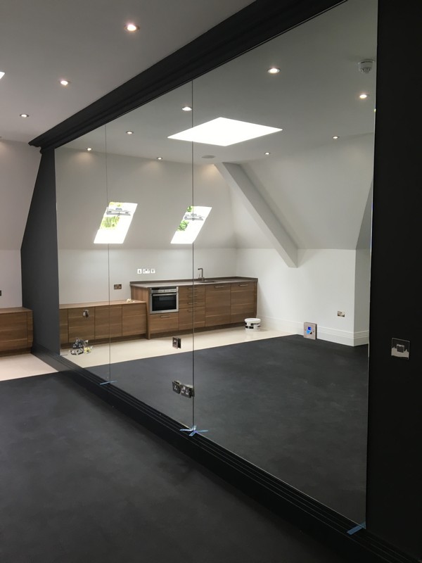 Frameless glass partition in loft conversion by Soho glaziers